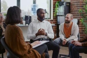 three people sit in a group therapy setting and discuss ways on controlling your anger