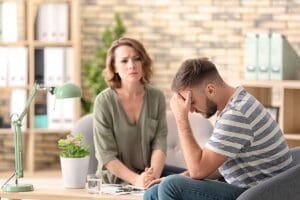 therapist sits on the couch while upset male patient needs help finding practices that focus on anger management strategies in greensburg pa