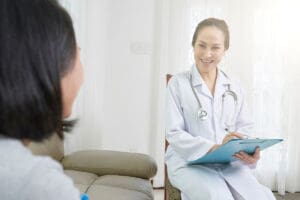 medical professional talks to patient about tms therapy